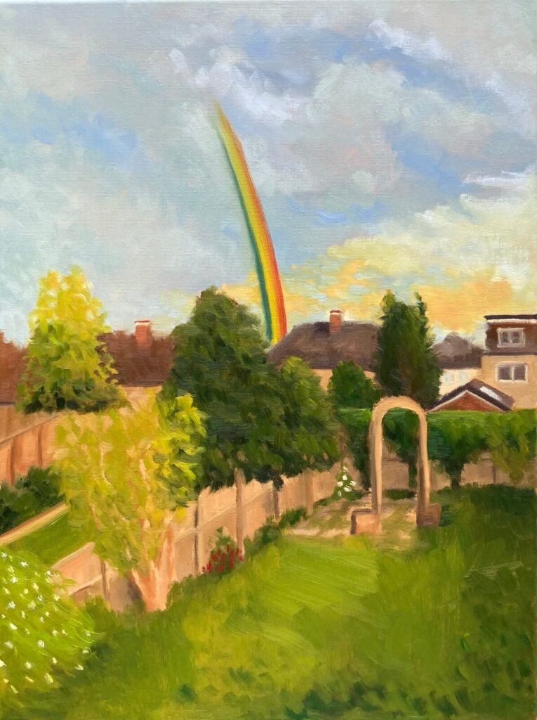 Oil painting of a rainbow arching over a lush English garden with golden sky and suburban rooftops