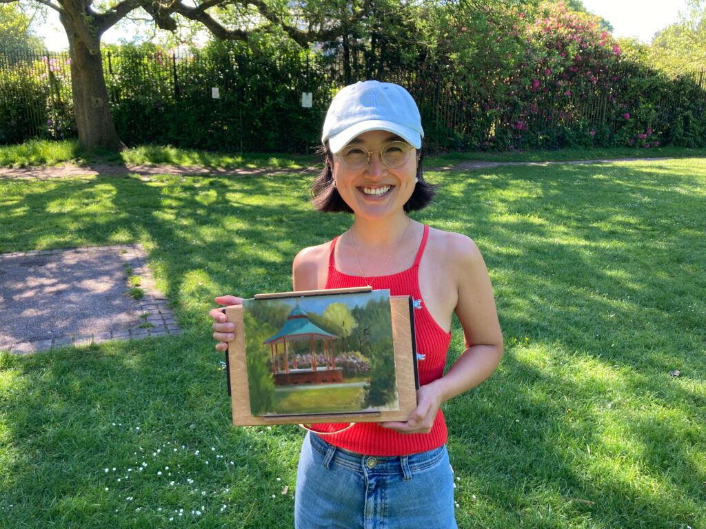 Chohee Jung holding a paint after a plein air session in Sefton park
