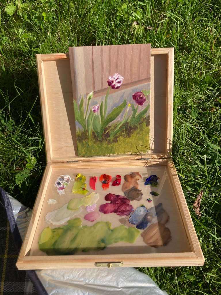 DIY pochade box with palette and small tulip oil painting in progress